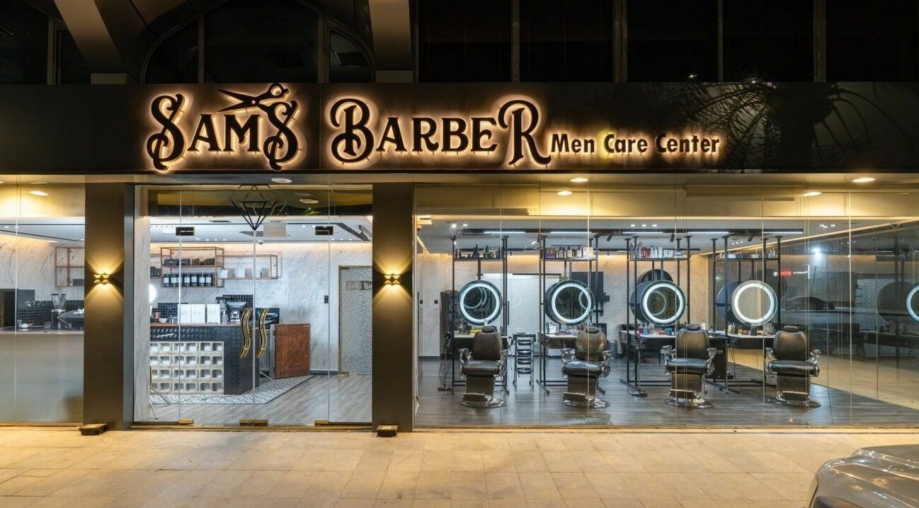 Sams Barber Men Care Center's elegant exterior at night in Abu Dhabi, Abu Dhabi, AE features inviting chairs.