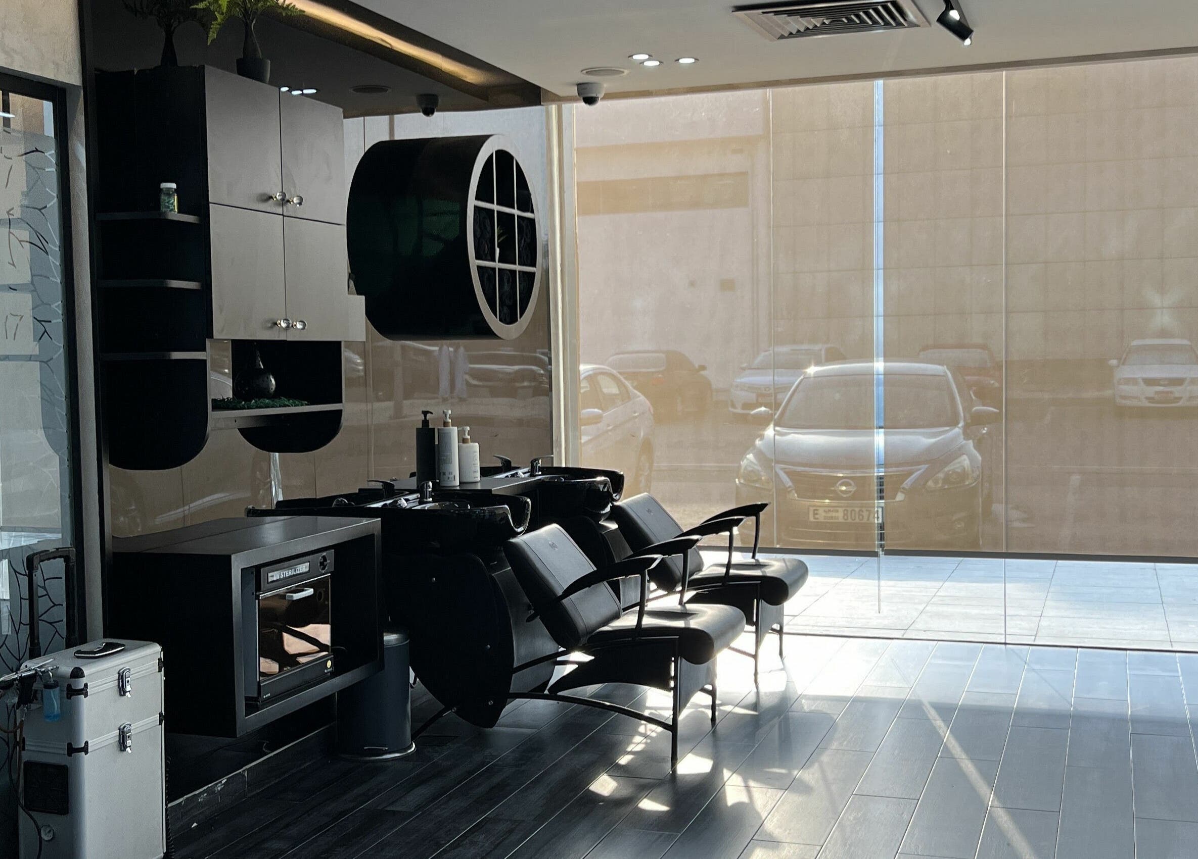 Contemporary interior of Sams Barber Men Care Center in Abu Dhabi, AE, featuring sleek chairs and modern decor.