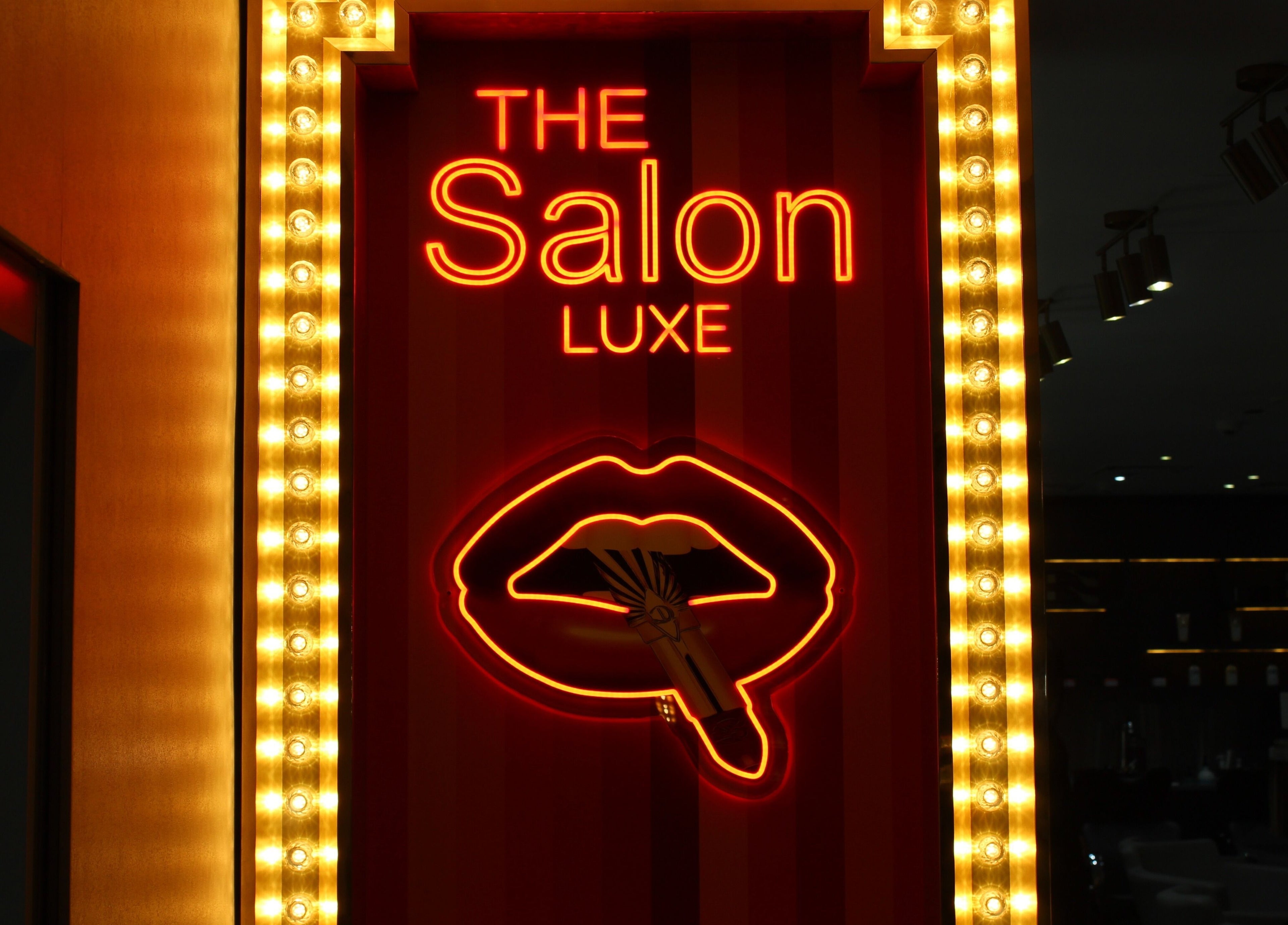 Illuminated sign of The Salon Luxe at Five JBR, Dubai, Dubai, AE with vibrant neon lights.