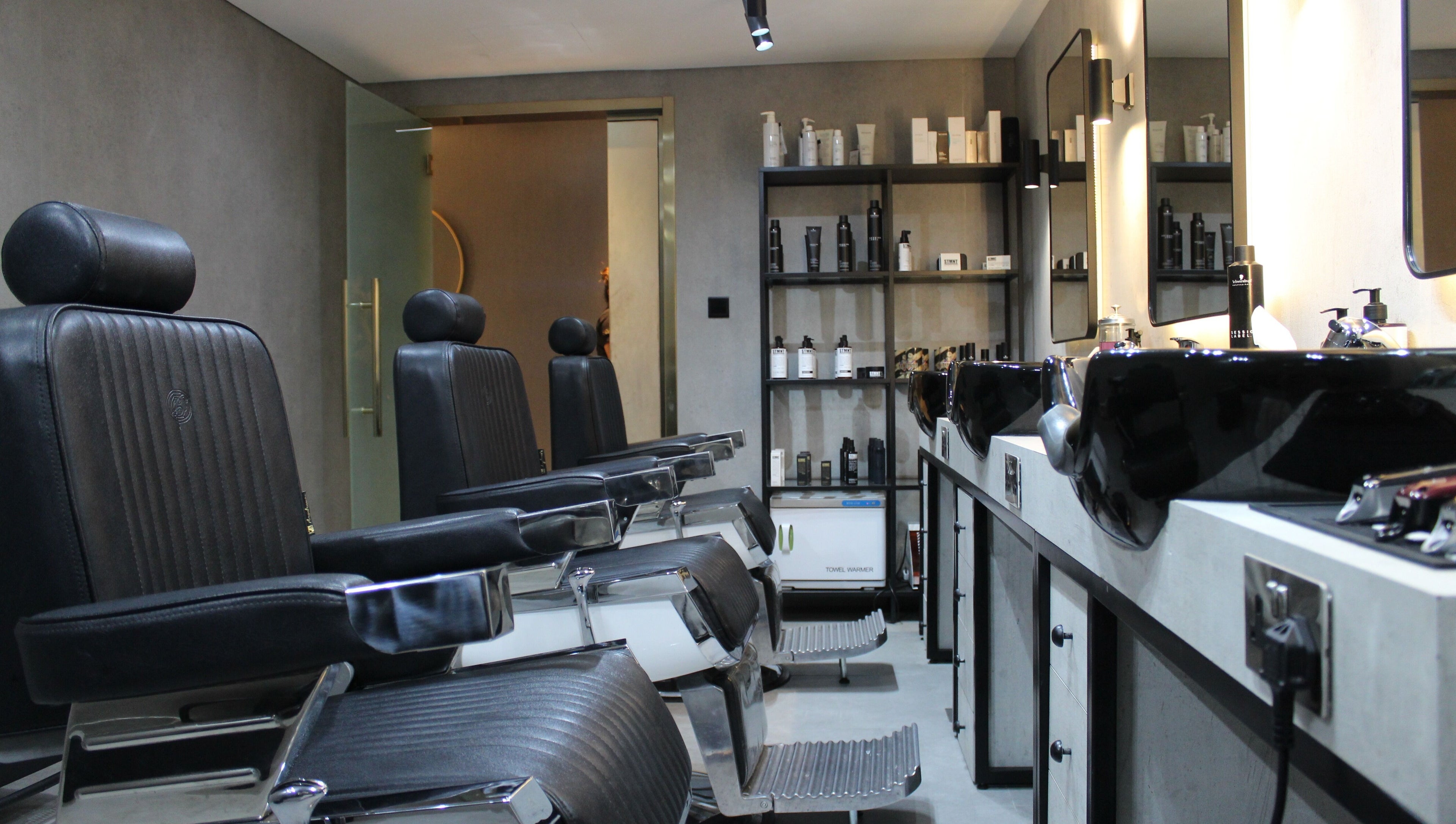 Modern barber chairs and products at The Salon Luxe, Dubai, Dubai, AE, offering premium grooming services.