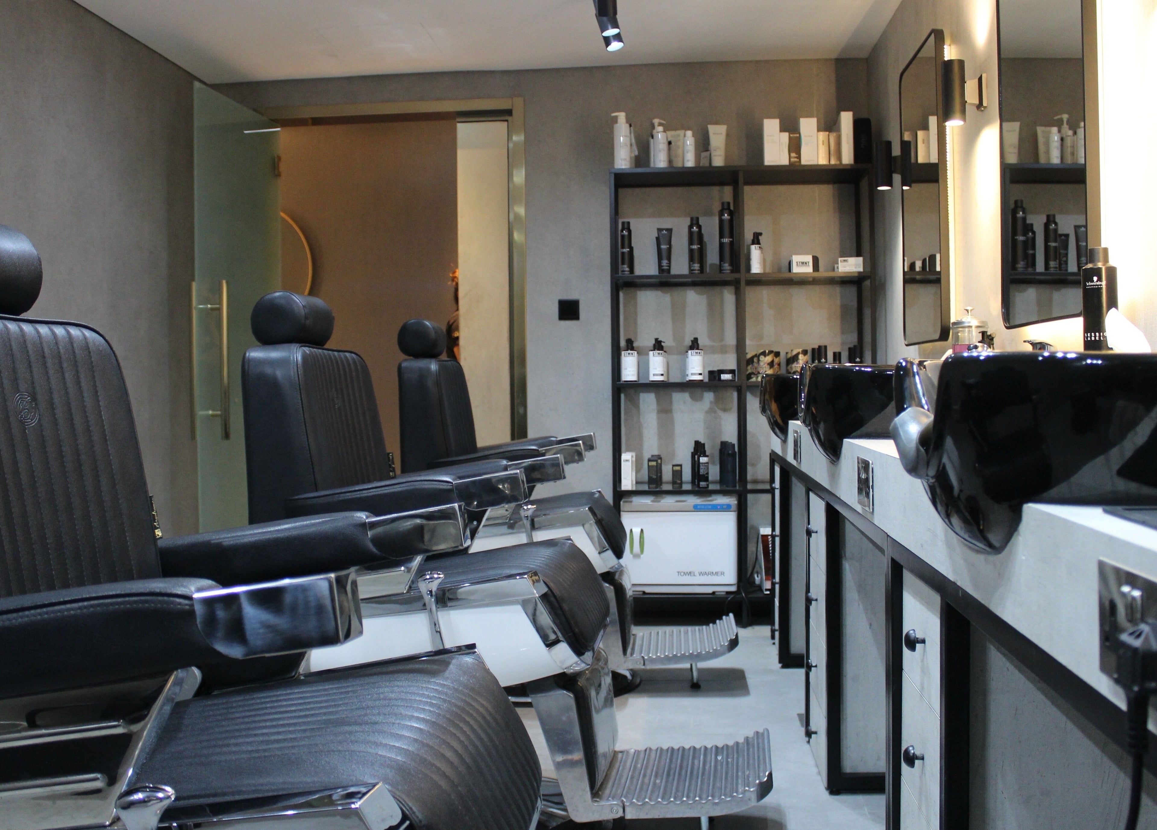 Modern barber chairs and products at The Salon Luxe, Dubai, Dubai, AE, offering premium grooming services.