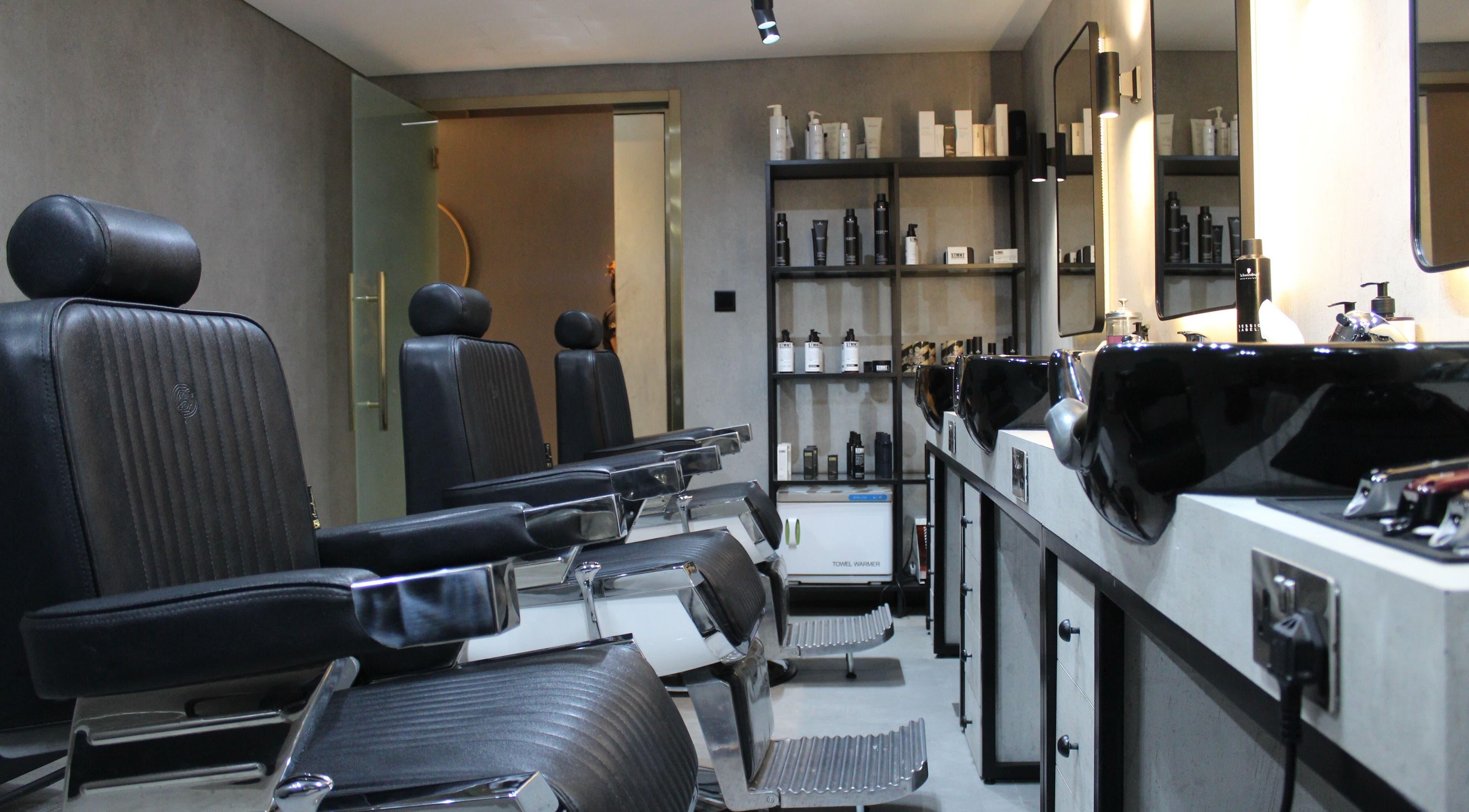 Modern barber chairs and products at The Salon Luxe, Dubai, Dubai, AE, offering premium grooming services.