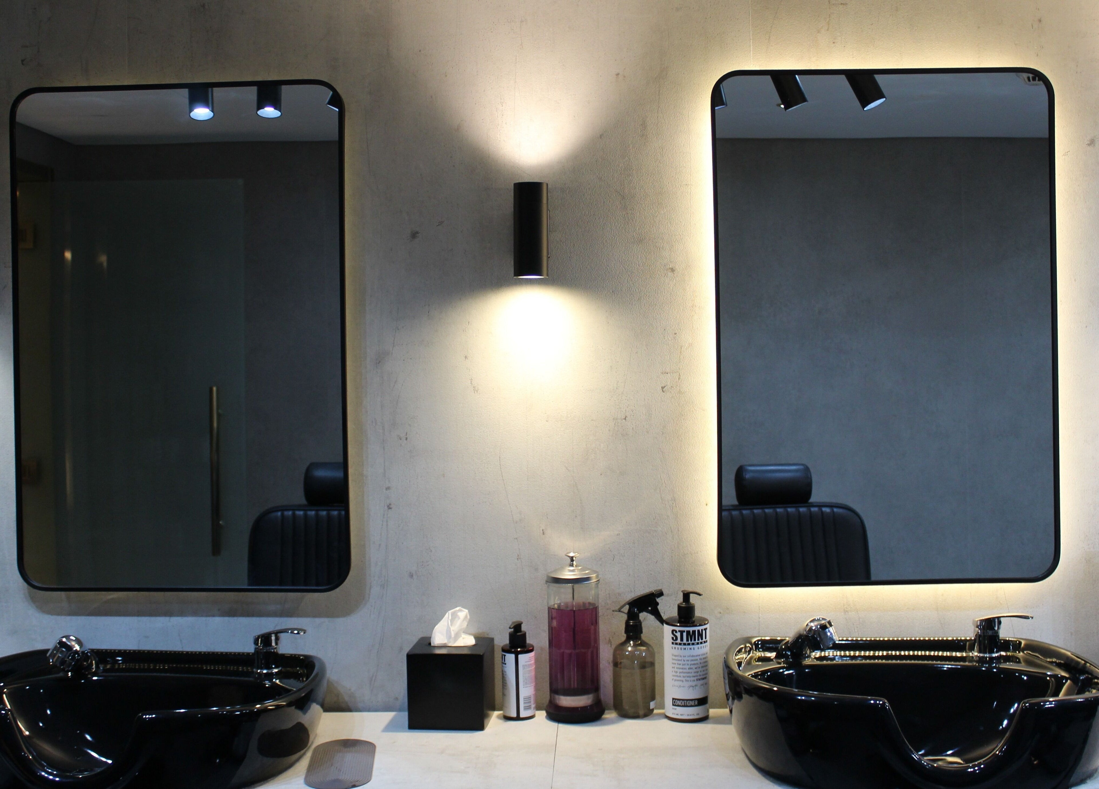 Elegant mirror setup at The Salon Luxe in Dubai, AE highlighting chic design and modern fixtures.