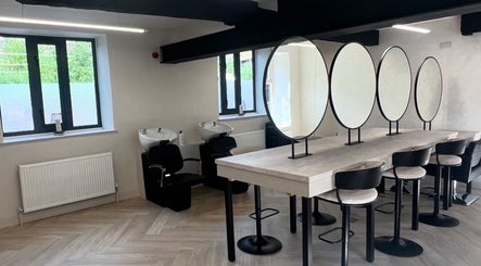 Modern beauty studio at Glam by Laura in Sheffield, England, GB featuring chic styling stations and mirrors.