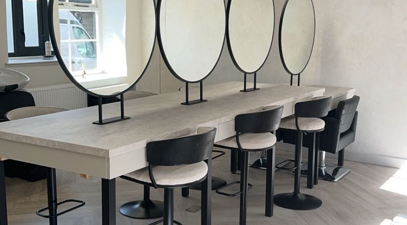 Modern salon mirrors and seating area at Glam by Laura in Sheffield, England, GB.