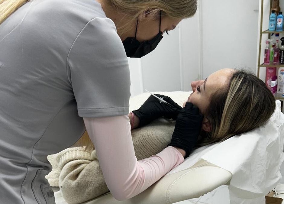 Aesthetic practitioner at Isabel Alexandra Aesthetics in Loughborough, England performing a facial treatment.