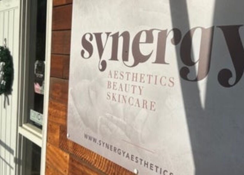 Entrance of Synergy Aesthetics Bexley, showcasing logo and festive wreath, located in Bexley, England, GB.