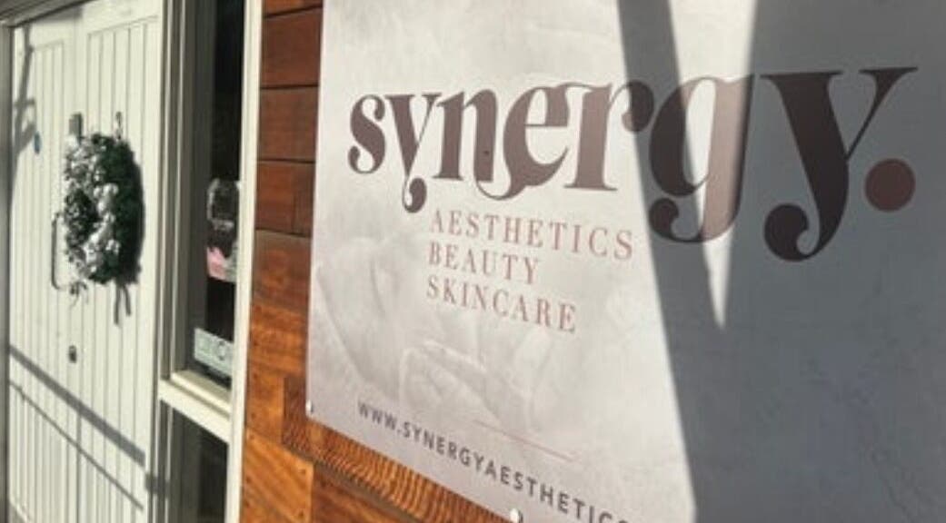 Entrance of Synergy Aesthetics Bexley, showcasing logo and festive wreath, located in Bexley, England, GB.