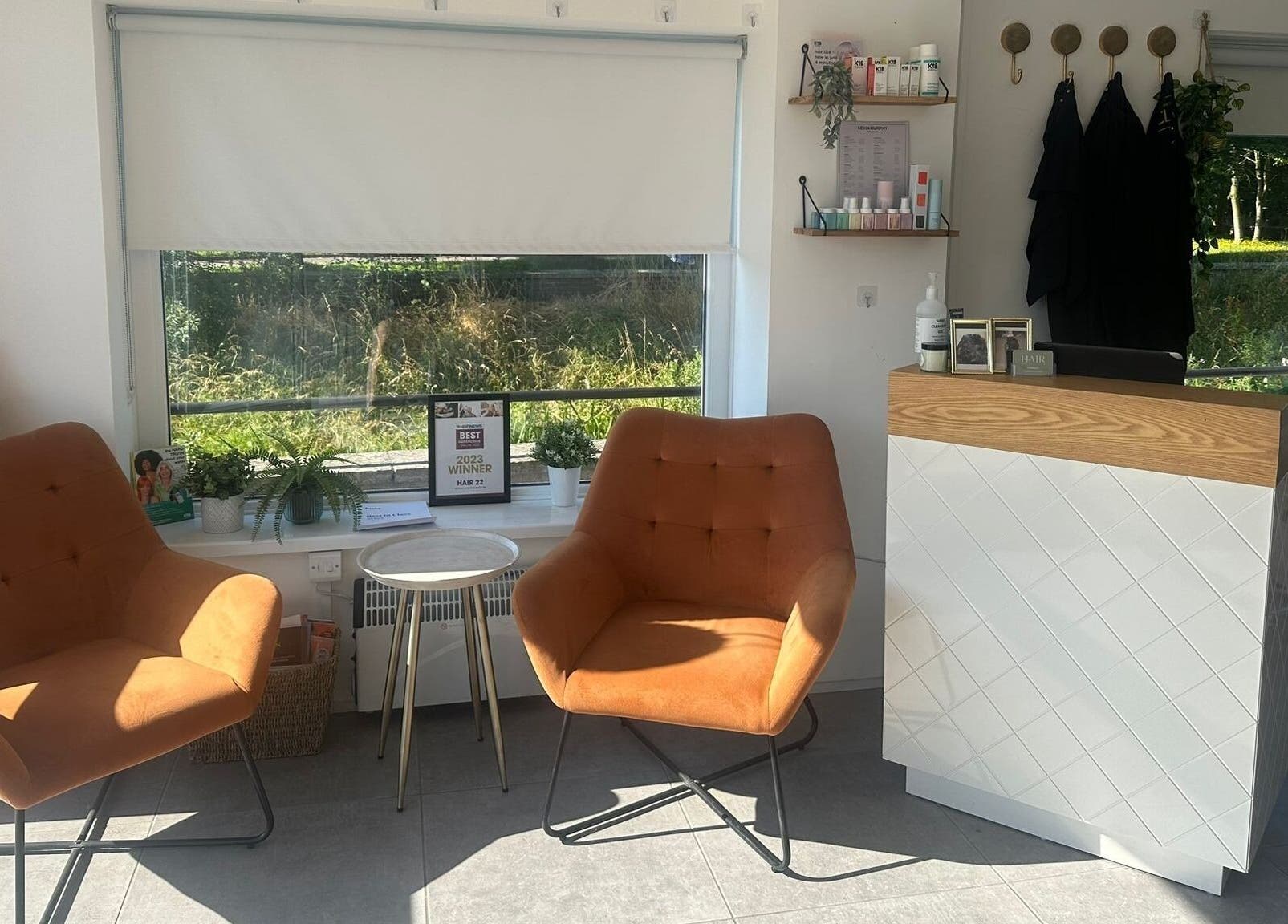 Inviting lounge area at Hair Twenty-Two, Bridport, England, GB, with stylish chairs and natural light.