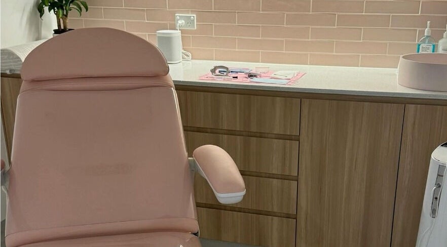 Cozy treatment room at The Teeth Whitening Boutique - Brisbane, Teneriffe, Queensland, AU with a soft pink chair and supplies.