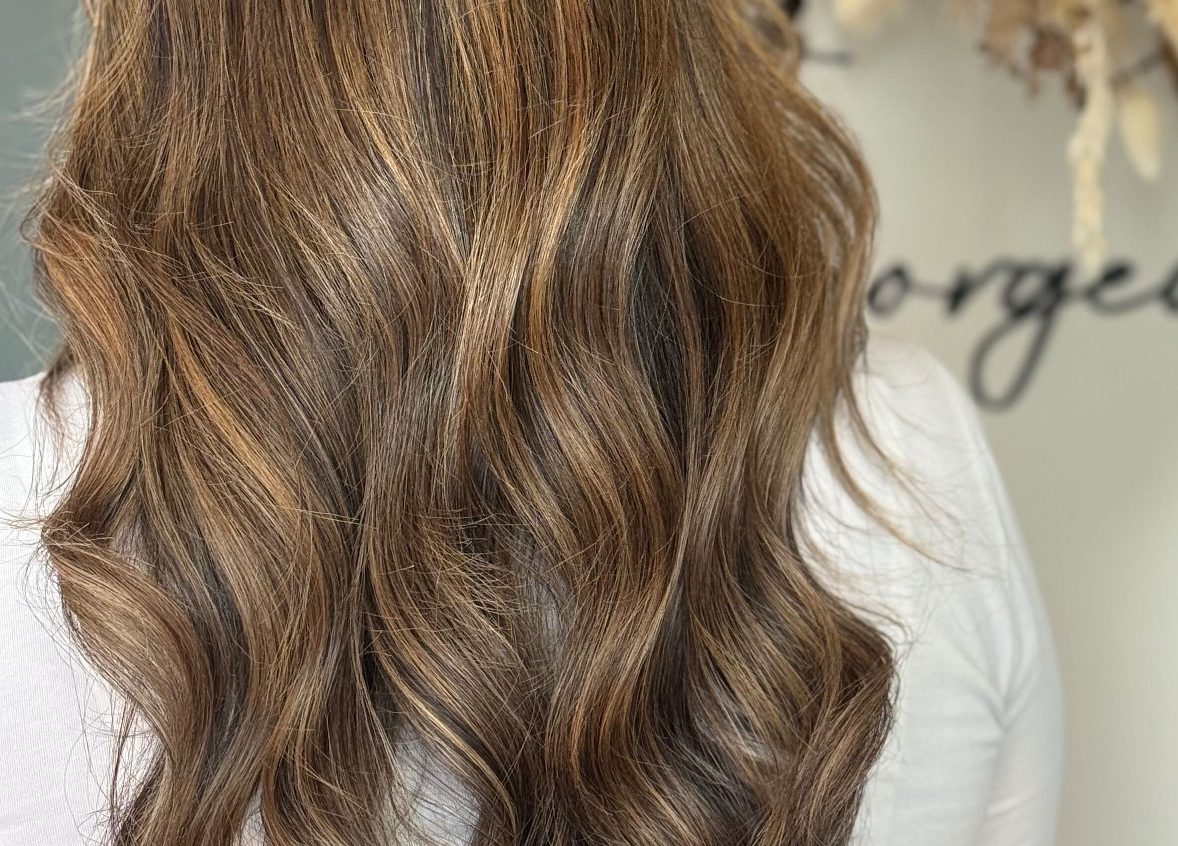 Wavy brown hairstyle at JR Hair Studio, Walnut Tree, England, GB.