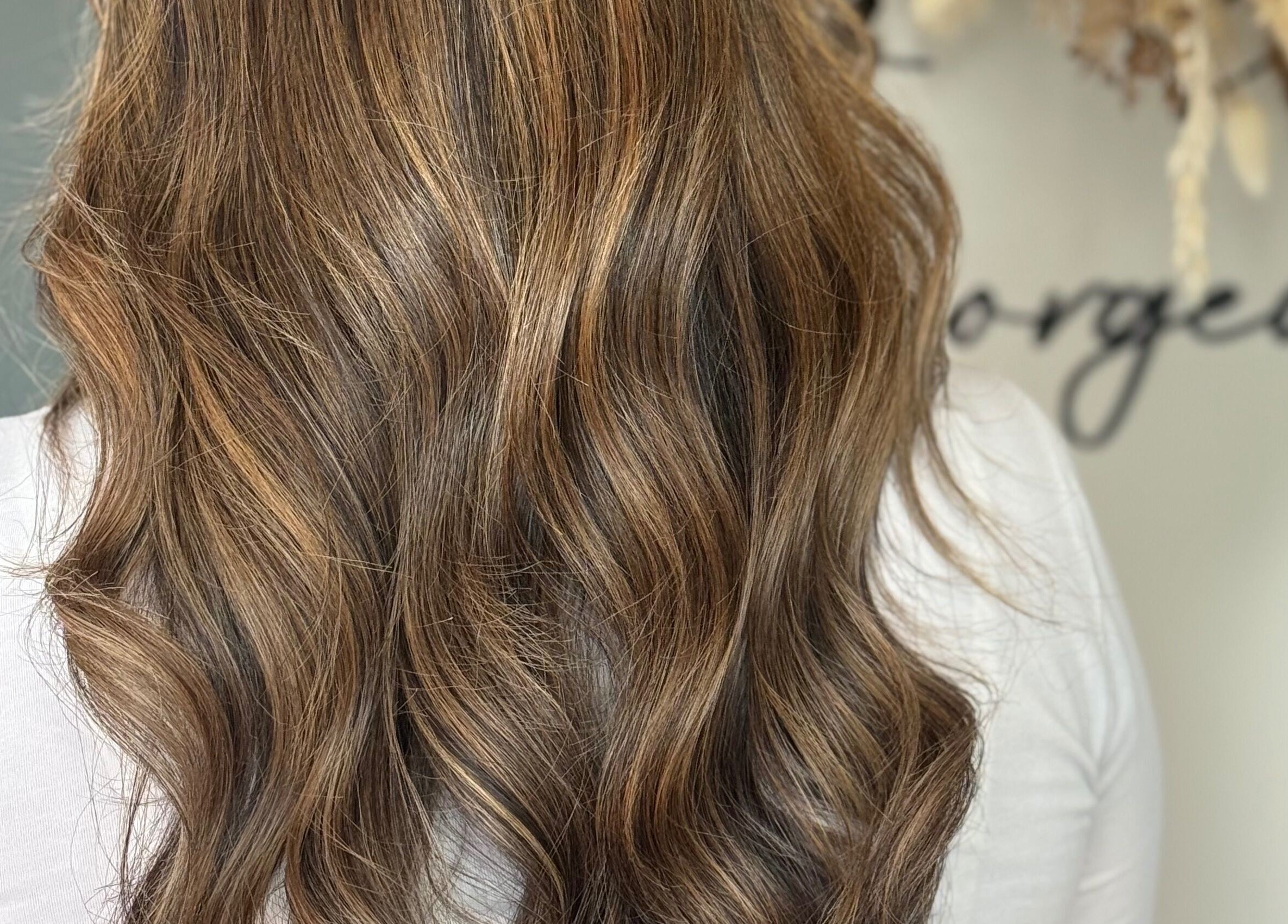 Wavy brown hairstyle at JR Hair Studio, Walnut Tree, England, GB.