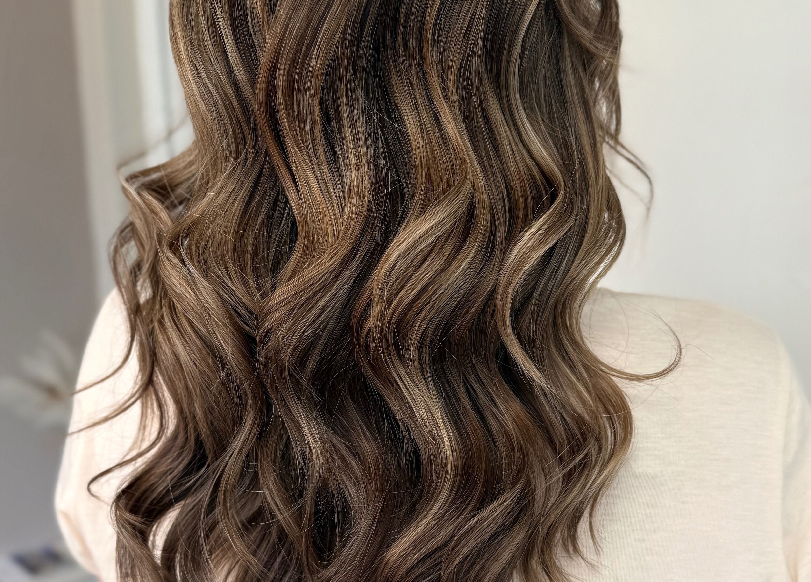 Elegant wavy hairstyle at JR Hair Studio, Walnut Tree, England, GB, showcasing rich brown tones.