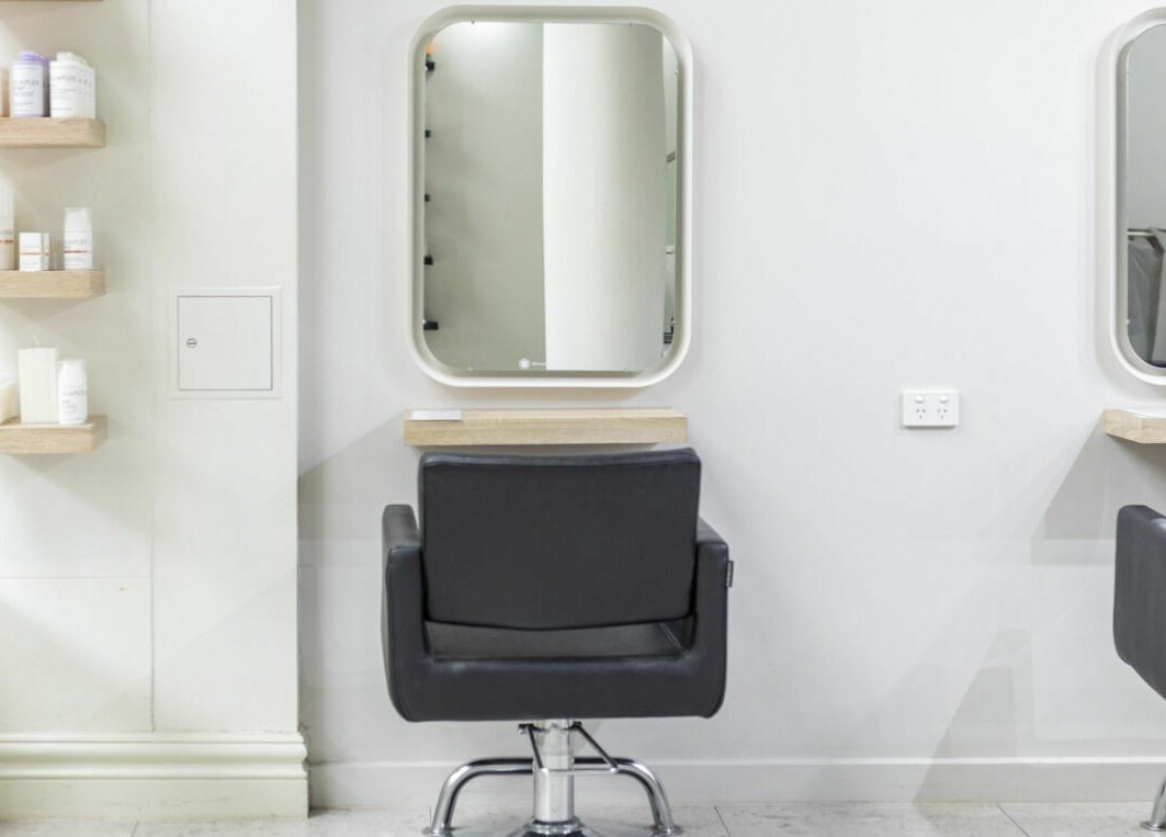 Elegant beauty station at House of Lox Neutral Bay, New South Wales, AU, featuring modern chairs and mirrors.