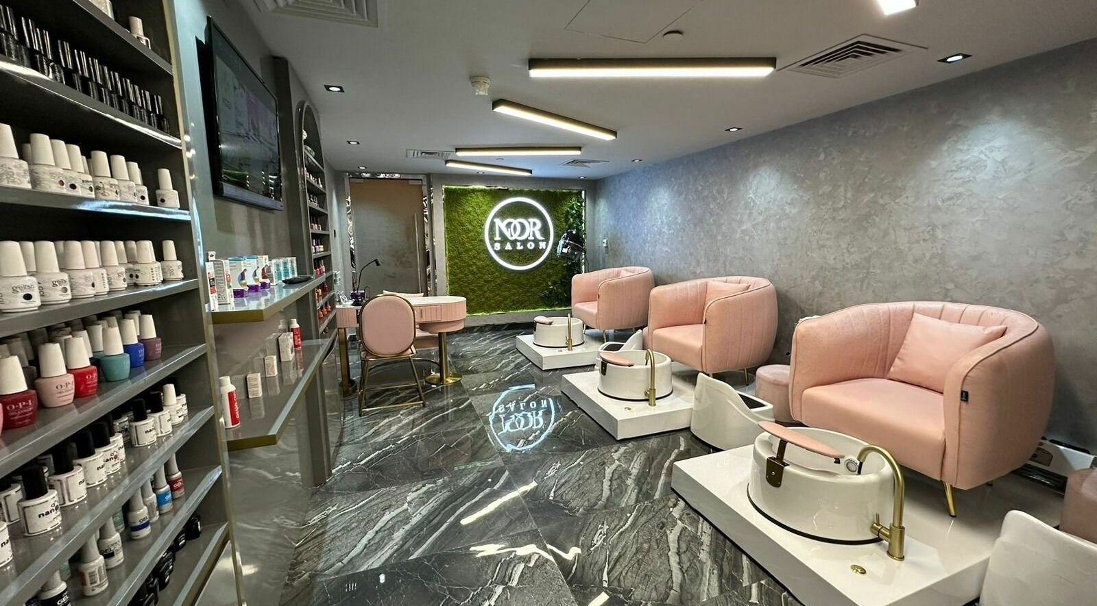 Luxurious pedicure area at Noor Beauty Salon | Beach Rotana, Abu Dhabi, AE with plush pink chairs and chic decor.