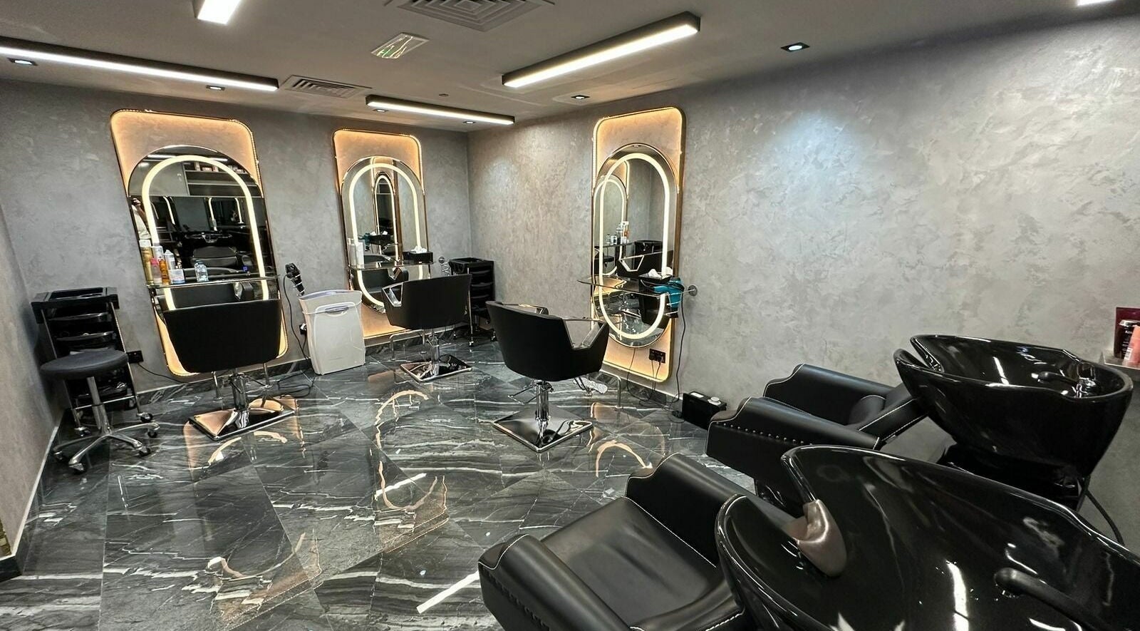 Spacious interior of Noor Beauty Salon at Beach Rotana, Abu Dhabi, AE with sleek salon chairs and mirrors.