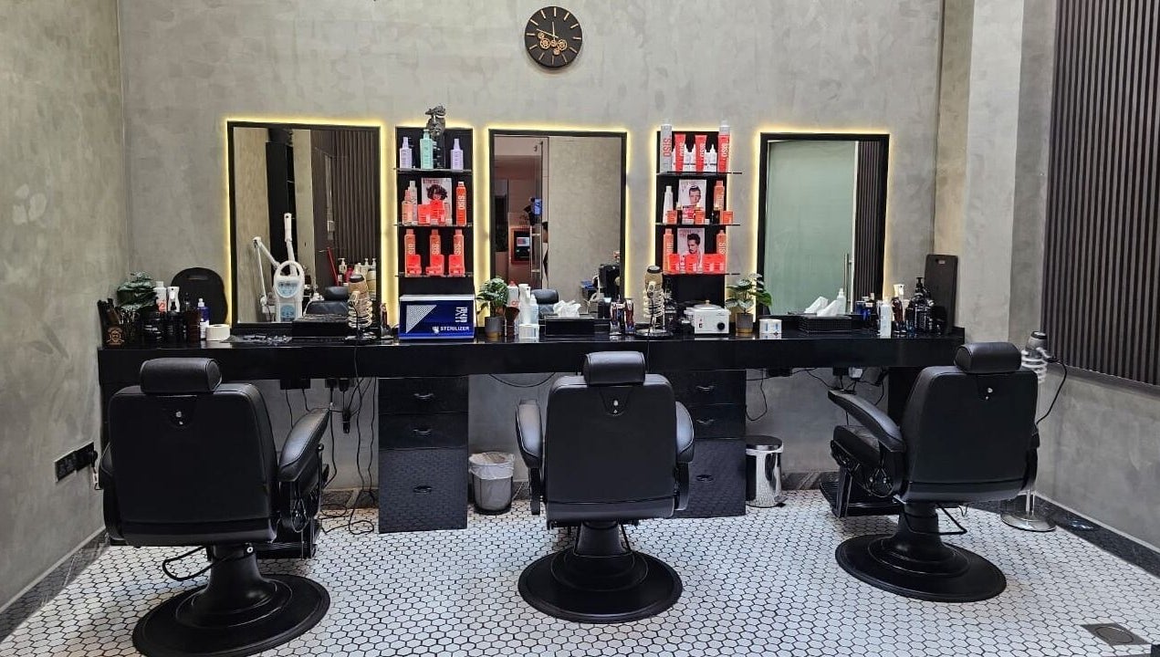 Chic salon setup at Noor Elasr Gents | Le Meridien in Abu Dhabi, Abu Dhabi, AE with styling chairs and grooming products.