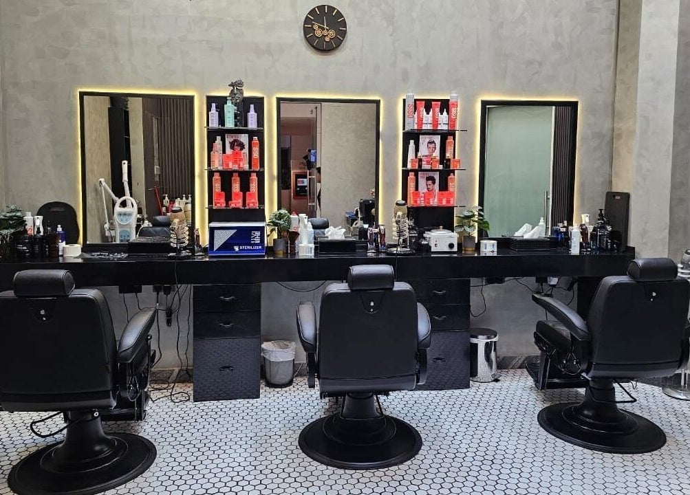 Chic salon setup at Noor Elasr Gents | Le Meridien in Abu Dhabi, Abu Dhabi, AE with styling chairs and grooming products.