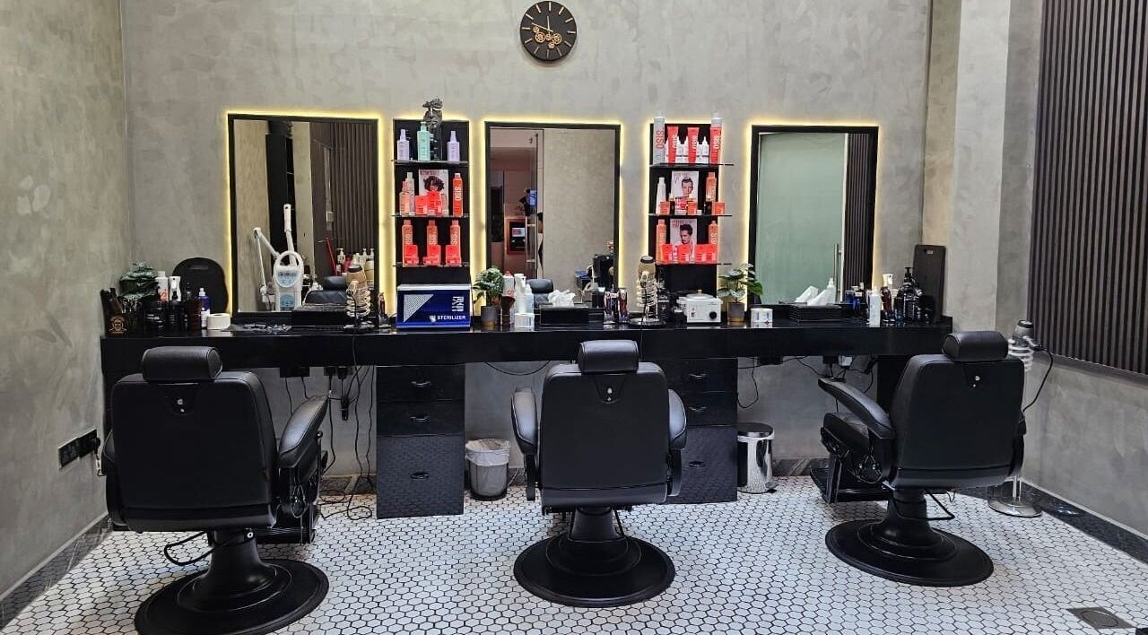 Chic salon setup at Noor Elasr Gents | Le Meridien in Abu Dhabi, Abu Dhabi, AE with styling chairs and grooming products.