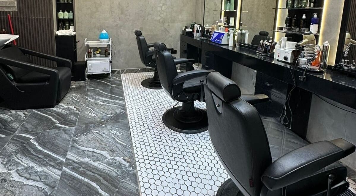 Luxurious interior of Noor Elasr Gents | Le Meridien in Abu Dhabi, AE showcasing stylish black leather chairs.