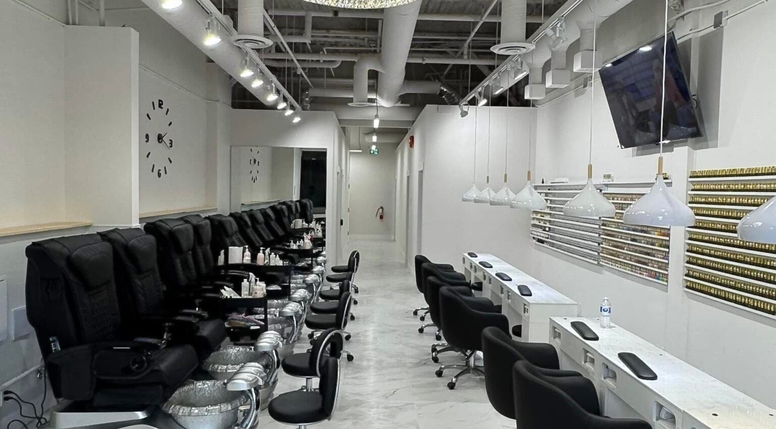 Inside view of Creative Nails and Esthetics, Burnaby, BC, CA showing luxurious nail stations and pedicure chairs.