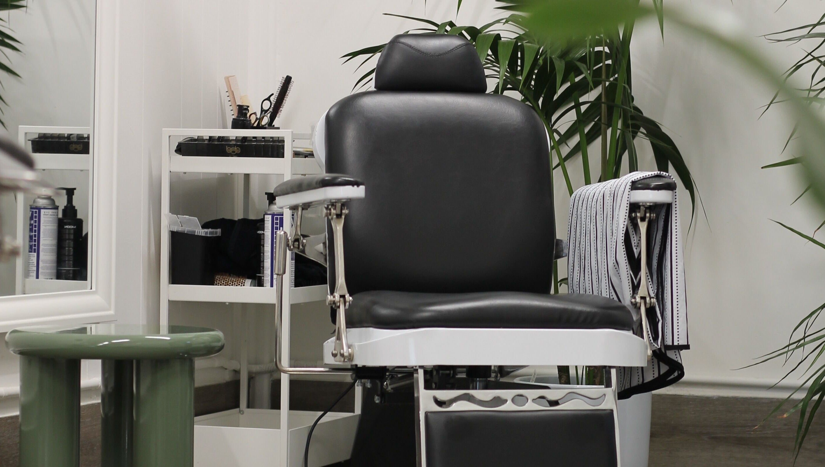 Modern barber chair at Locale Barber Studio, West Beach, South Australia, AU, showcasing elegant interior.