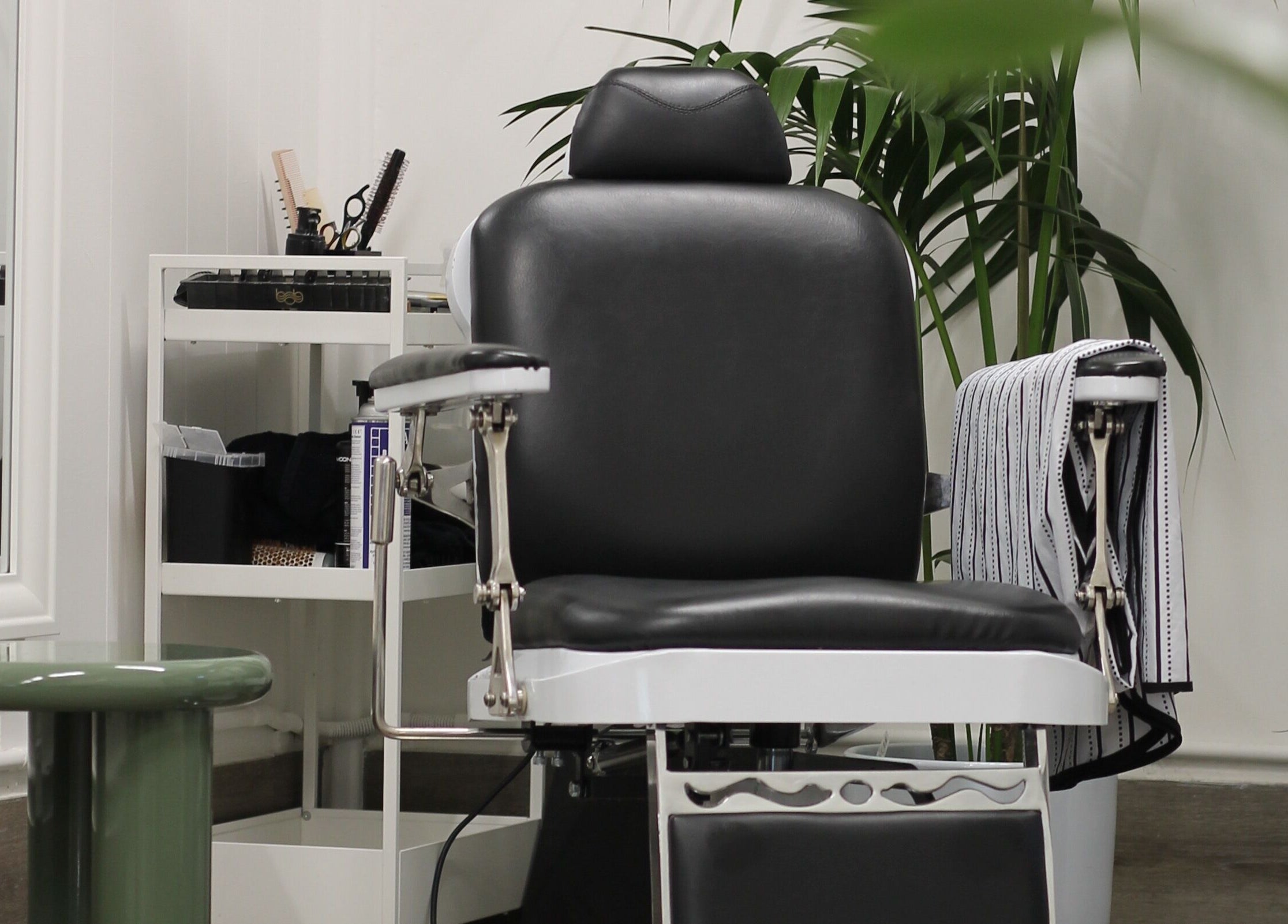 Modern barber chair at Locale Barber Studio, West Beach, South Australia, AU, showcasing elegant interior.