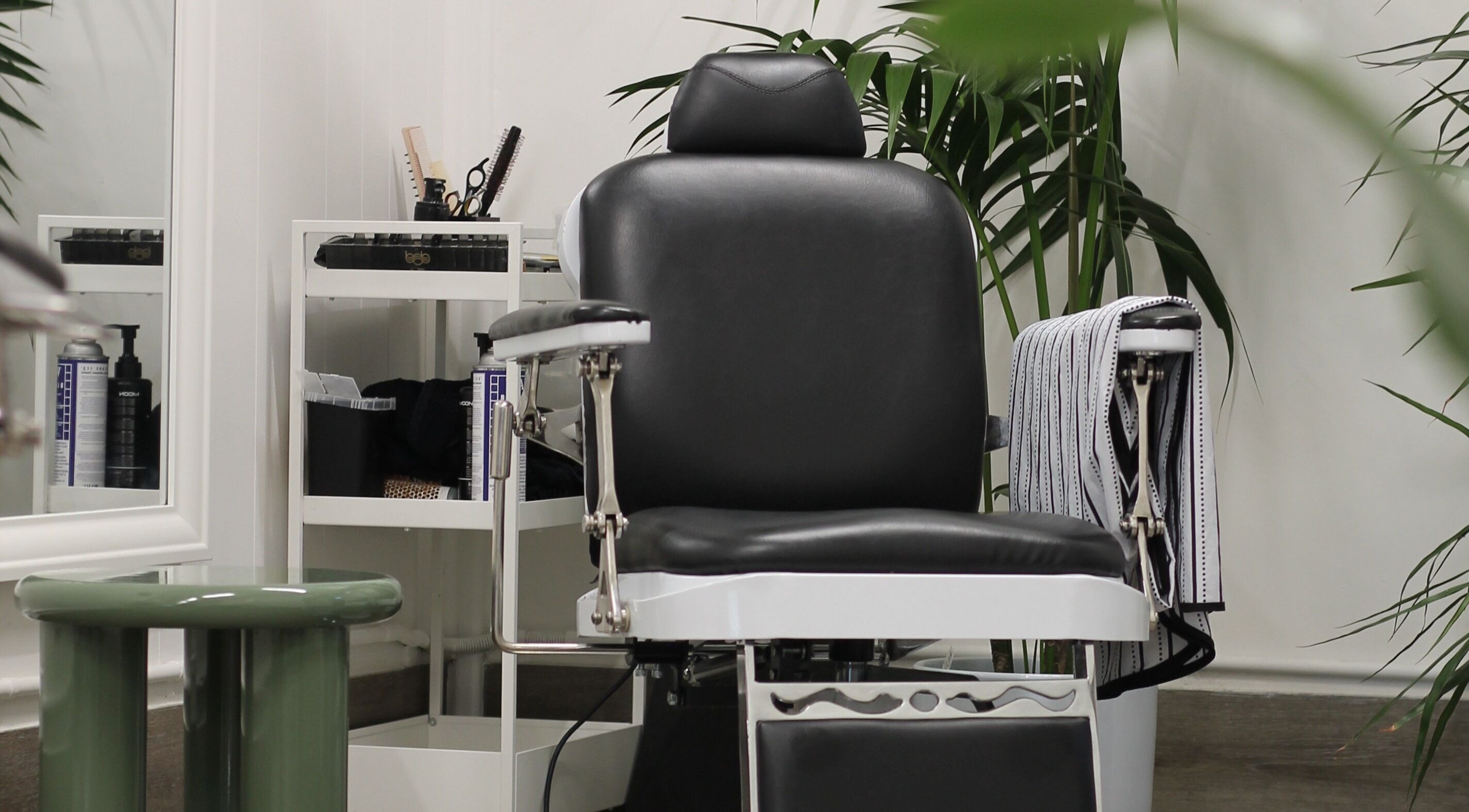 Modern barber chair at Locale Barber Studio, West Beach, South Australia, AU, showcasing elegant interior.