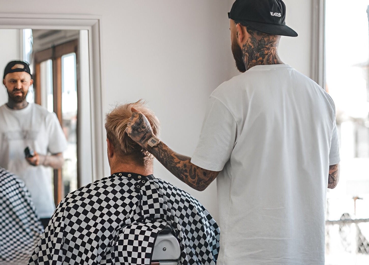 Stylist at Locale Barber Studio in West Beach, South Australia, AU giving a client a trendy haircut.
