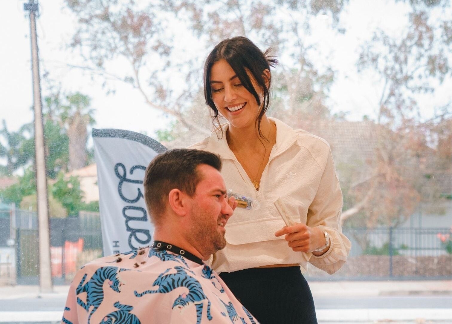 Smiling stylist with client at Locale Barber Studio in West Beach, South Australia, AU.