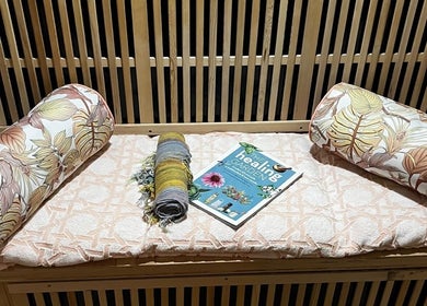 Relaxation setup with pillows and healing book at Sunset Salt Therapy, Sunset Beach, Western Australia, AU.