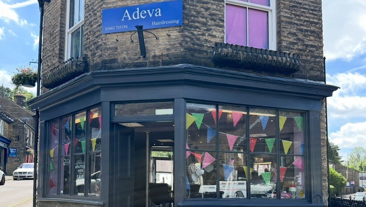 Front view of Adeva Hairdressing Whaley Bridge with colorful flags. Located in Whaley Bridge, England, GB.