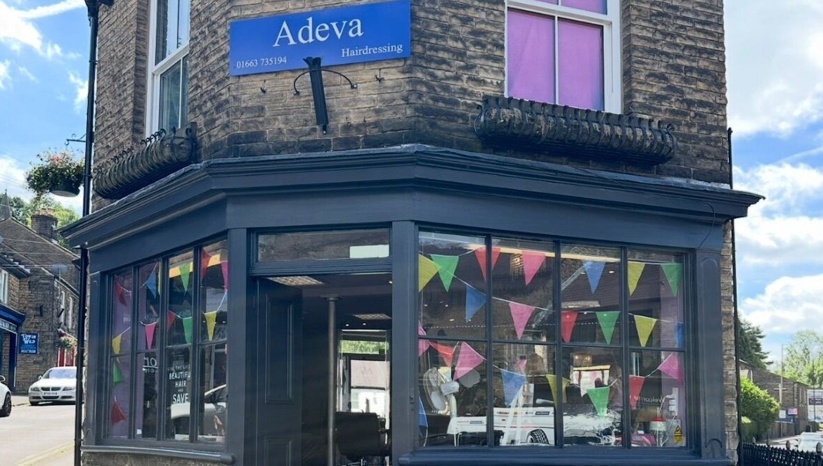 Front view of Adeva Hairdressing Whaley Bridge with colorful flags. Located in Whaley Bridge, England, GB.