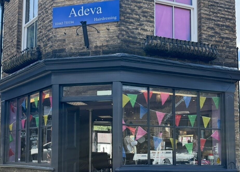 Front view of Adeva Hairdressing Whaley Bridge with colorful flags. Located in Whaley Bridge, England, GB.