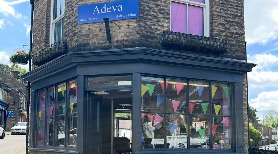 Front view of Adeva Hairdressing Whaley Bridge with colorful flags. Located in Whaley Bridge, England, GB.