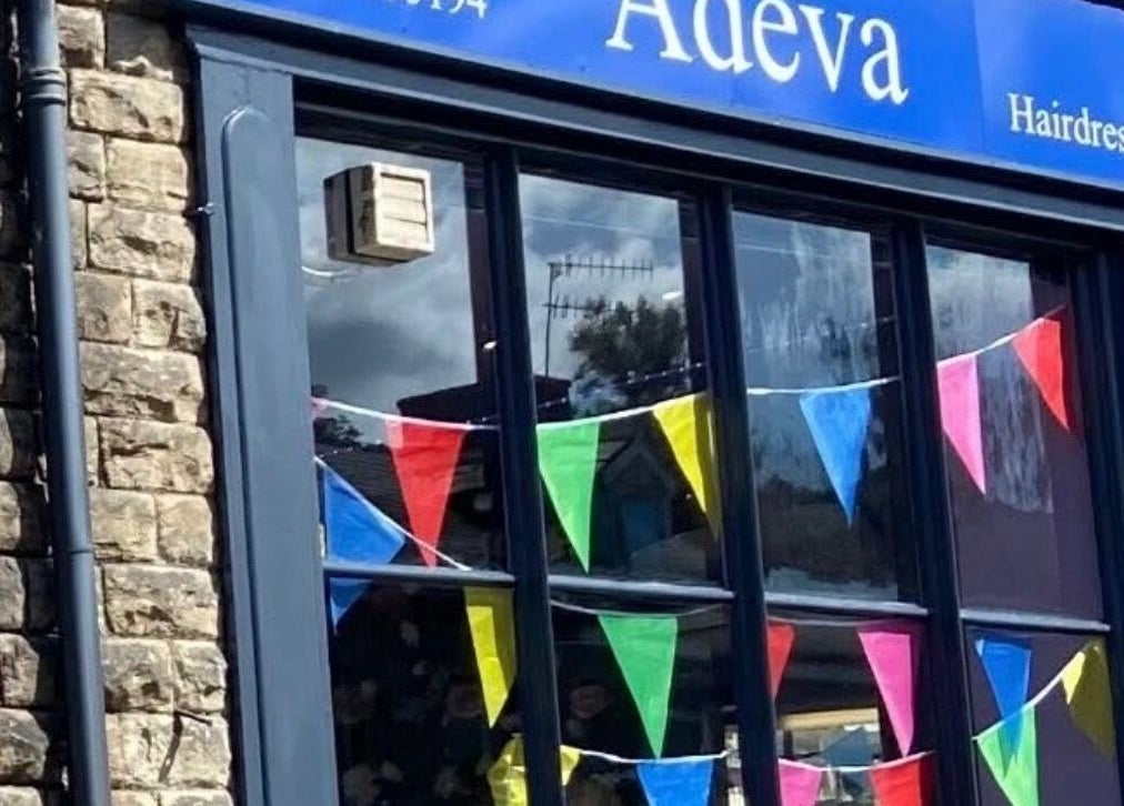 Exterior of Adeva Hairdressing Whaley Bridge with colorful bunting at Whaley Bridge, England, GB.