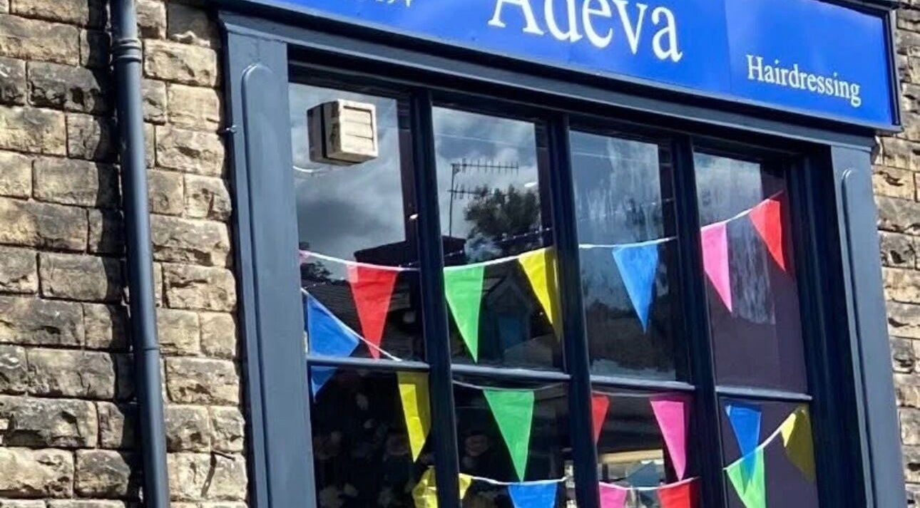 Exterior of Adeva Hairdressing Whaley Bridge with colorful bunting at Whaley Bridge, England, GB.