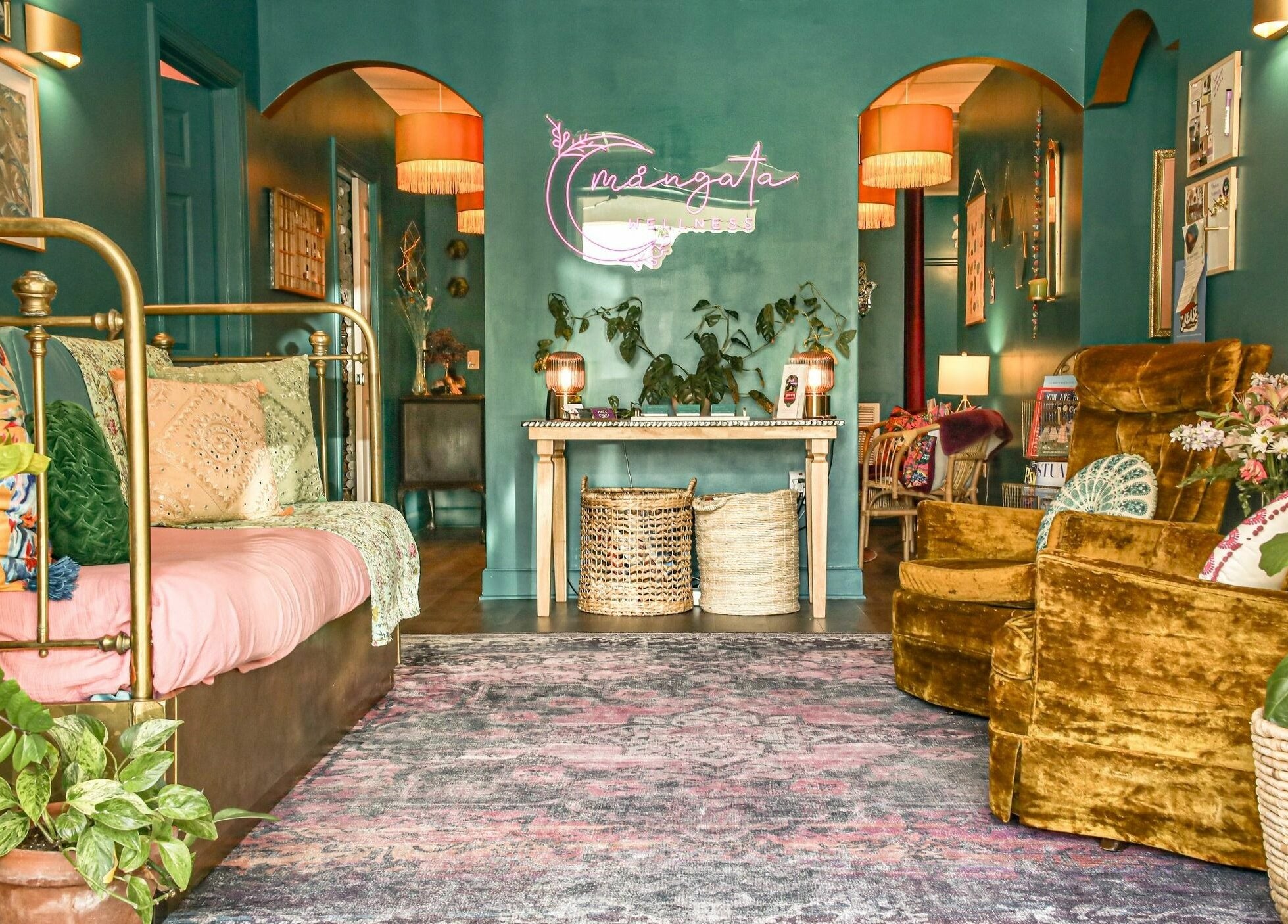 Cozy interior of ASHI Bodywork in Stuart, Florida, US, featuring vibrant velvet seating and decorative accents.