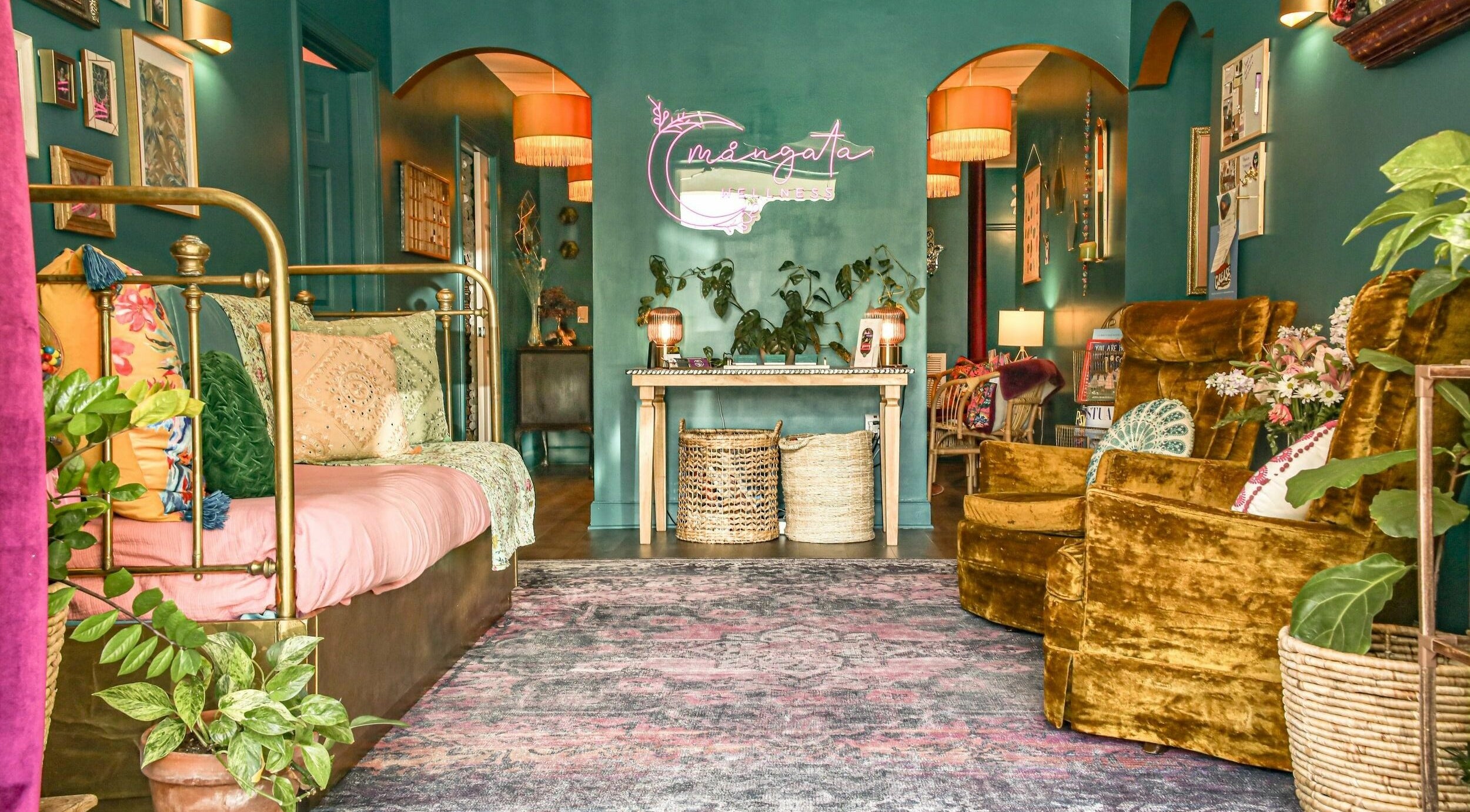 Cozy interior of ASHI Bodywork in Stuart, Florida, US, featuring vibrant velvet seating and decorative accents.