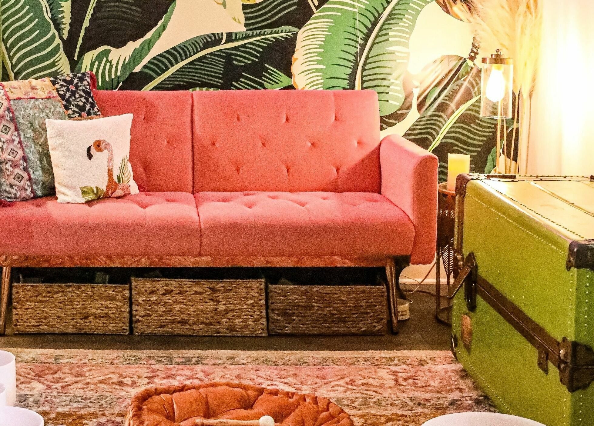 Chic pink sofa with vibrant decor in ASHI Bodywork, Stuart, Florida, US, creating a tranquil tropical vibe.