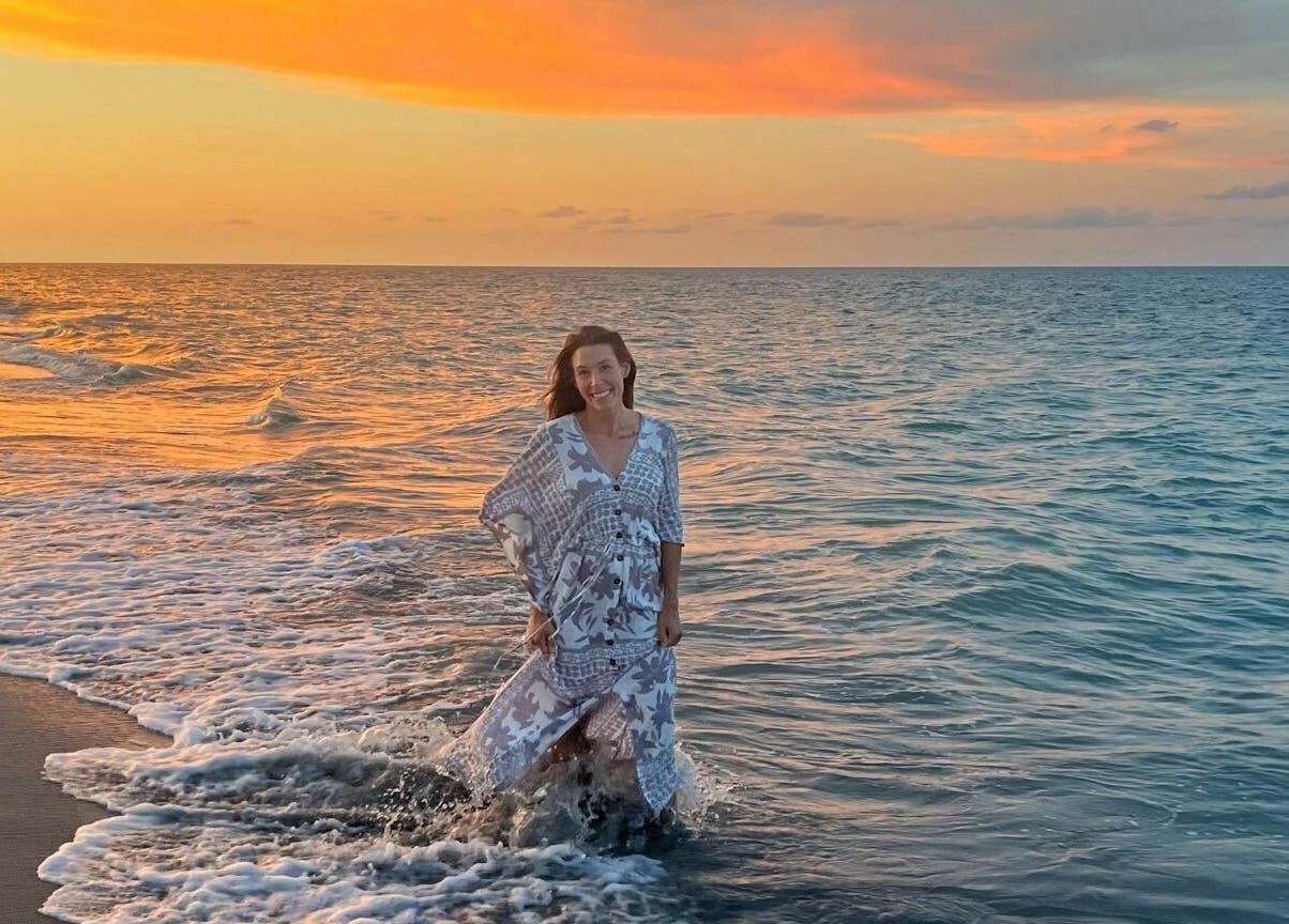 Person embracing sunset along the beach near ASHI Bodywork, Stuart, Florida, US.