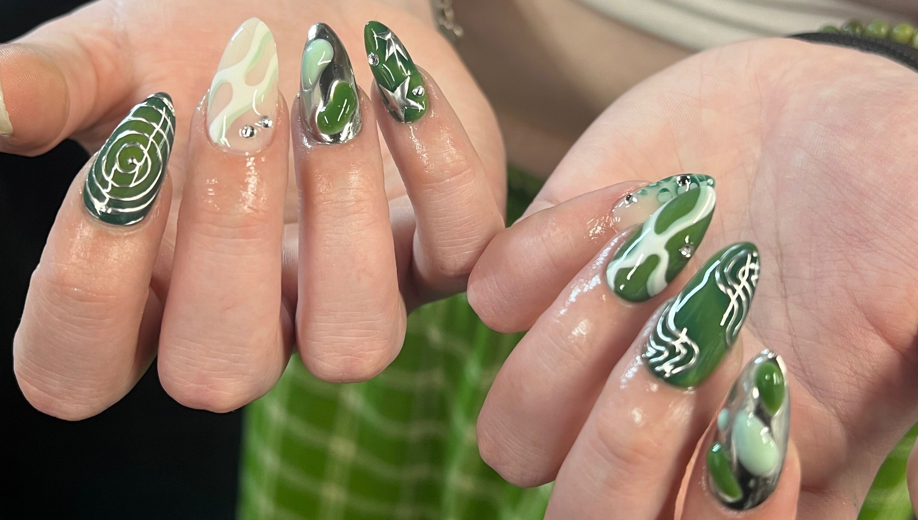 Intricate green nail art at KTF Studios in Cardiff, Wales, GB, showcasing unique design and vibrant colors.