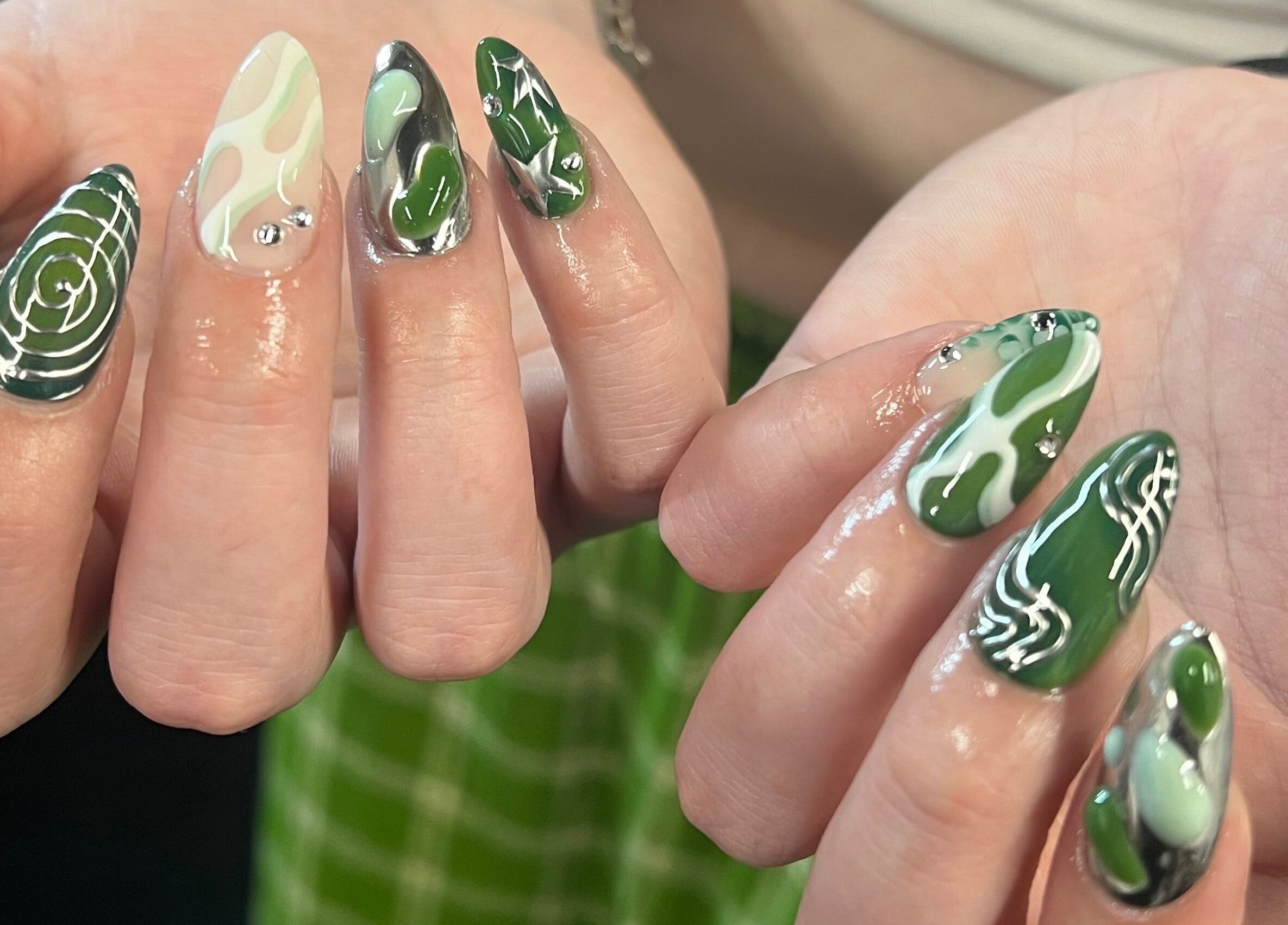 Intricate green nail art at KTF Studios in Cardiff, Wales, GB, showcasing unique design and vibrant colors.