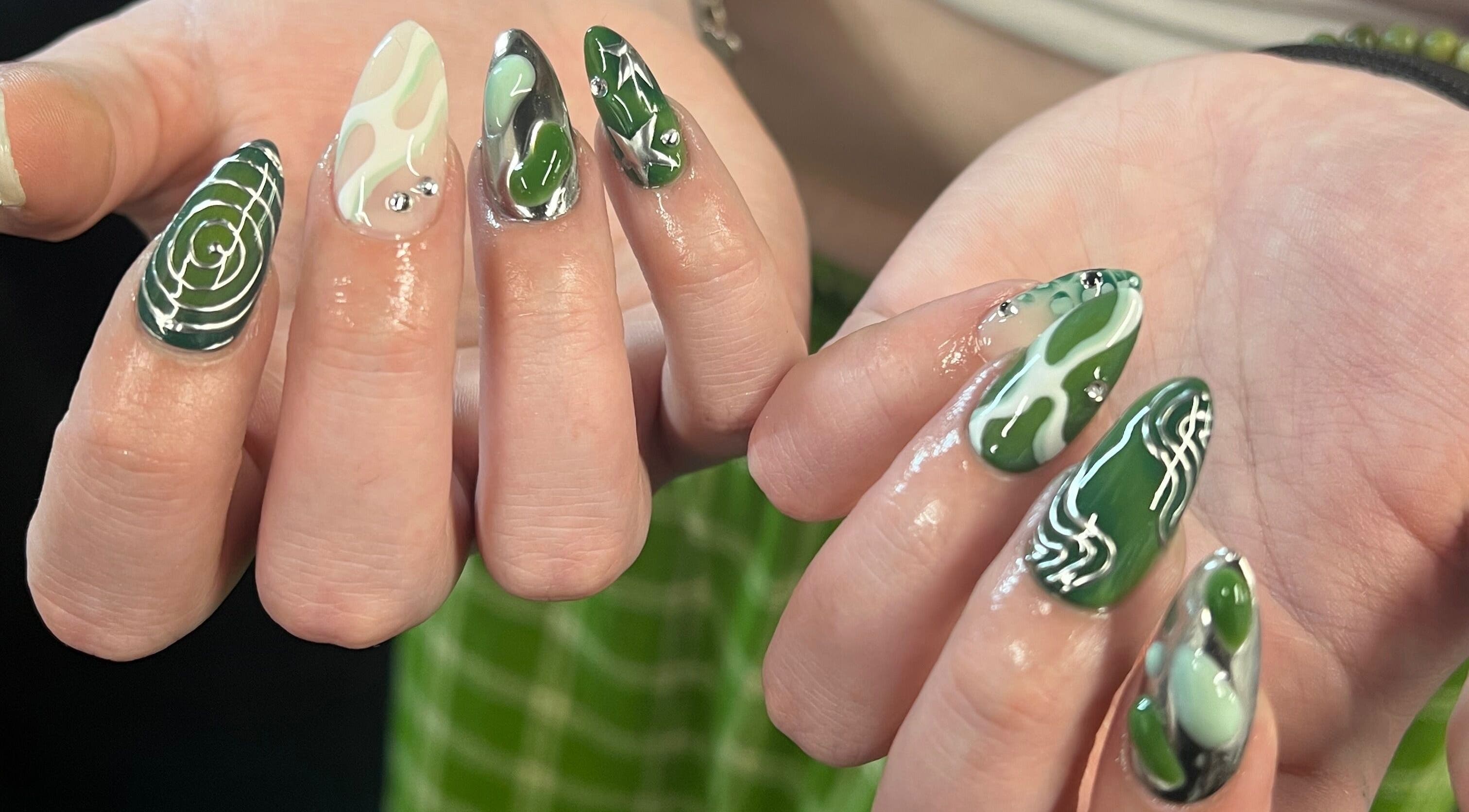 Intricate green nail art at KTF Studios in Cardiff, Wales, GB, showcasing unique design and vibrant colors.