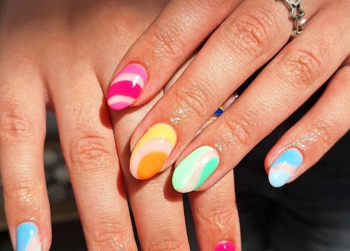 Vibrant rainbow nails manicure at KTF Studios, Cardiff, Wales, GB showcasing colorful nail art.
