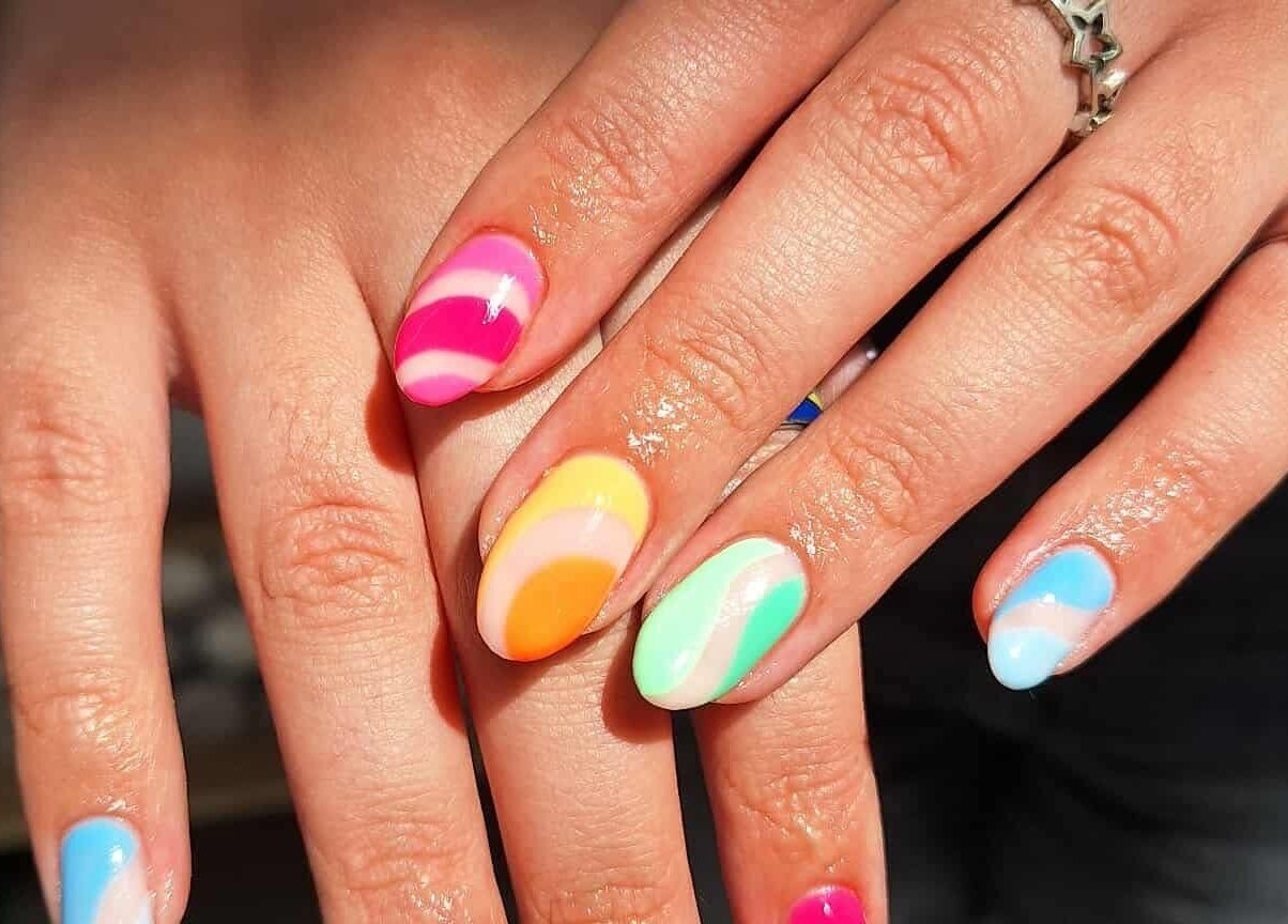 Vibrant rainbow nails manicure at KTF Studios, Cardiff, Wales, GB showcasing colorful nail art.