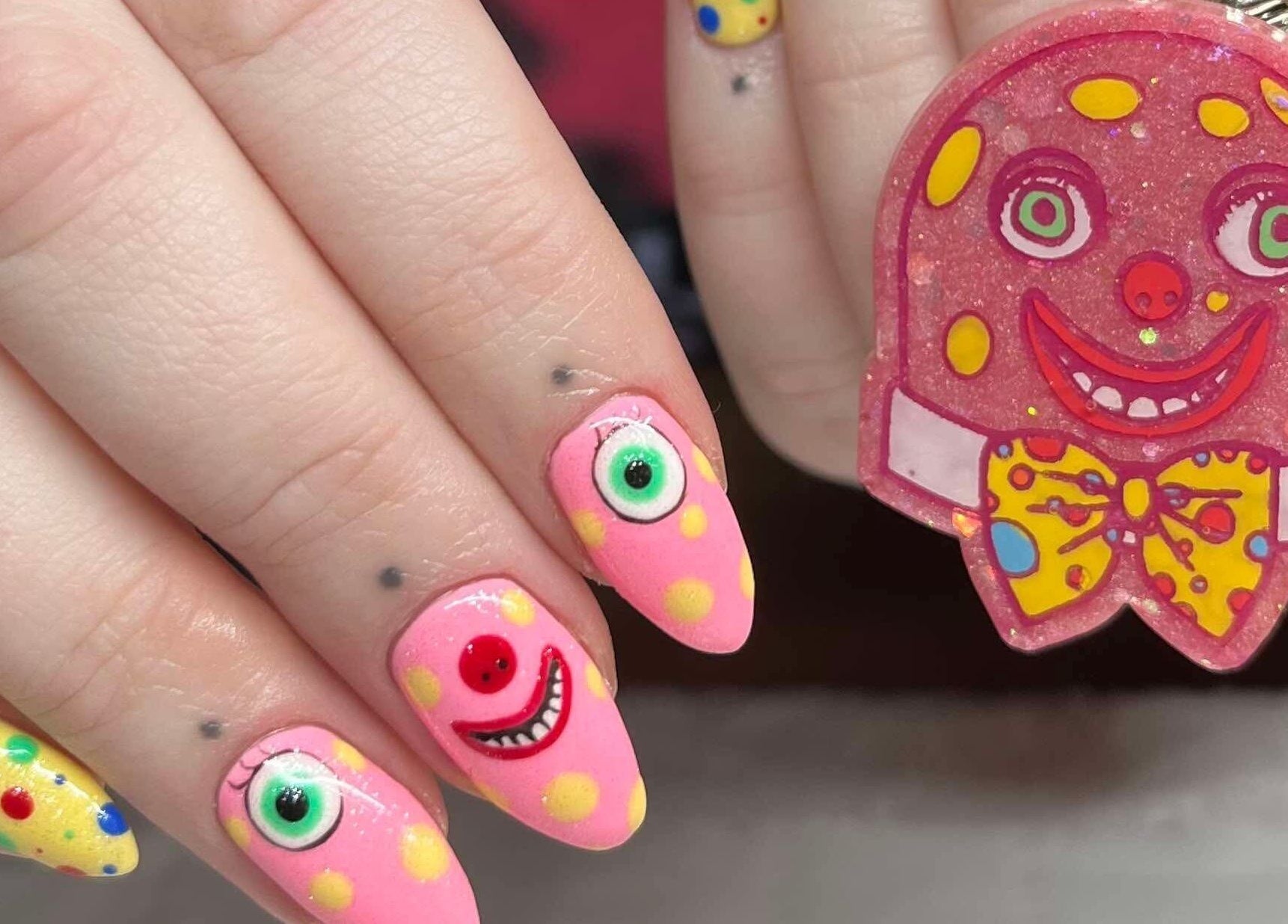 Colorful nail art with smiley faces at KTF Studios, Cardiff, Wales, GB.