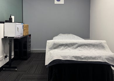 Calm treatment room at Body Go Clinic in Melbourne, Victoria, AU, featuring a massage table and modern decor.