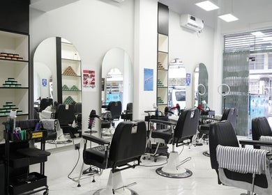 Modern interior of EVRDY Barbershop - San Chaung, Yangon, featuring stylish chairs and mirrors.