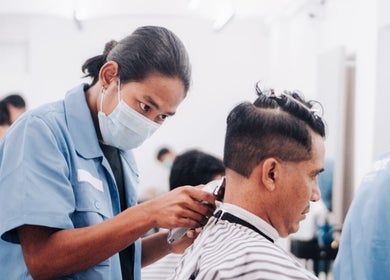 Barber at EVRDY Barbershop - San Chaung gives a precise haircut. Yangon, Yangon Region, MM